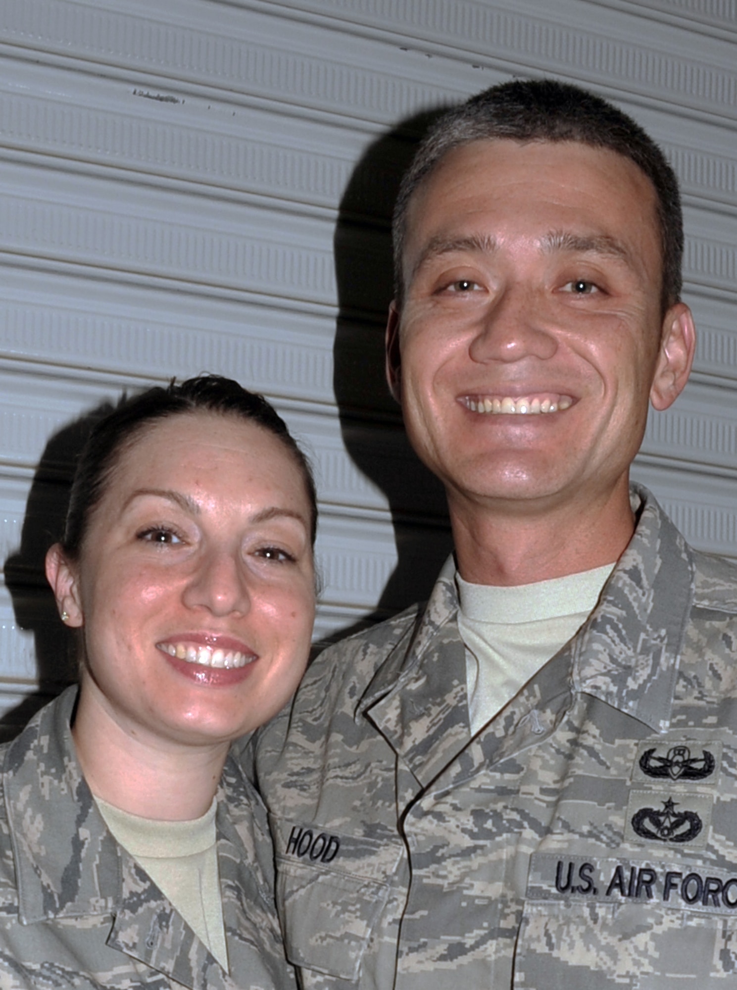 Tech. Sgt. Wendy Hood, a command post craftsman with the 380th Air Expeditionary Wing, stops for a photos with her husband, Tech. Sgt. Robert Hood, an explosive ordnance technician with the 380th Expeditionary Civil Engineer Squadron, at a non-disclosed base in Southwest Asia on April 21, 2010. They are both deployed together for the first time and celebrated their 10th wedding anniversary on April 22. Both of the Sergeants Hood are deployed from Hill Air Force Base, Utah. Sergeant Robert Hood is from the 775th Civil Engineer Squadron and his hometown is Killeen, Texas. Sergeant Wendy Hood is from the 75th Air Base Wing Command Post and her hometown is Hooksett, N.H. (U.S. Air Force Photo/Master Sgt. Scott T. Sturkol/Released)
