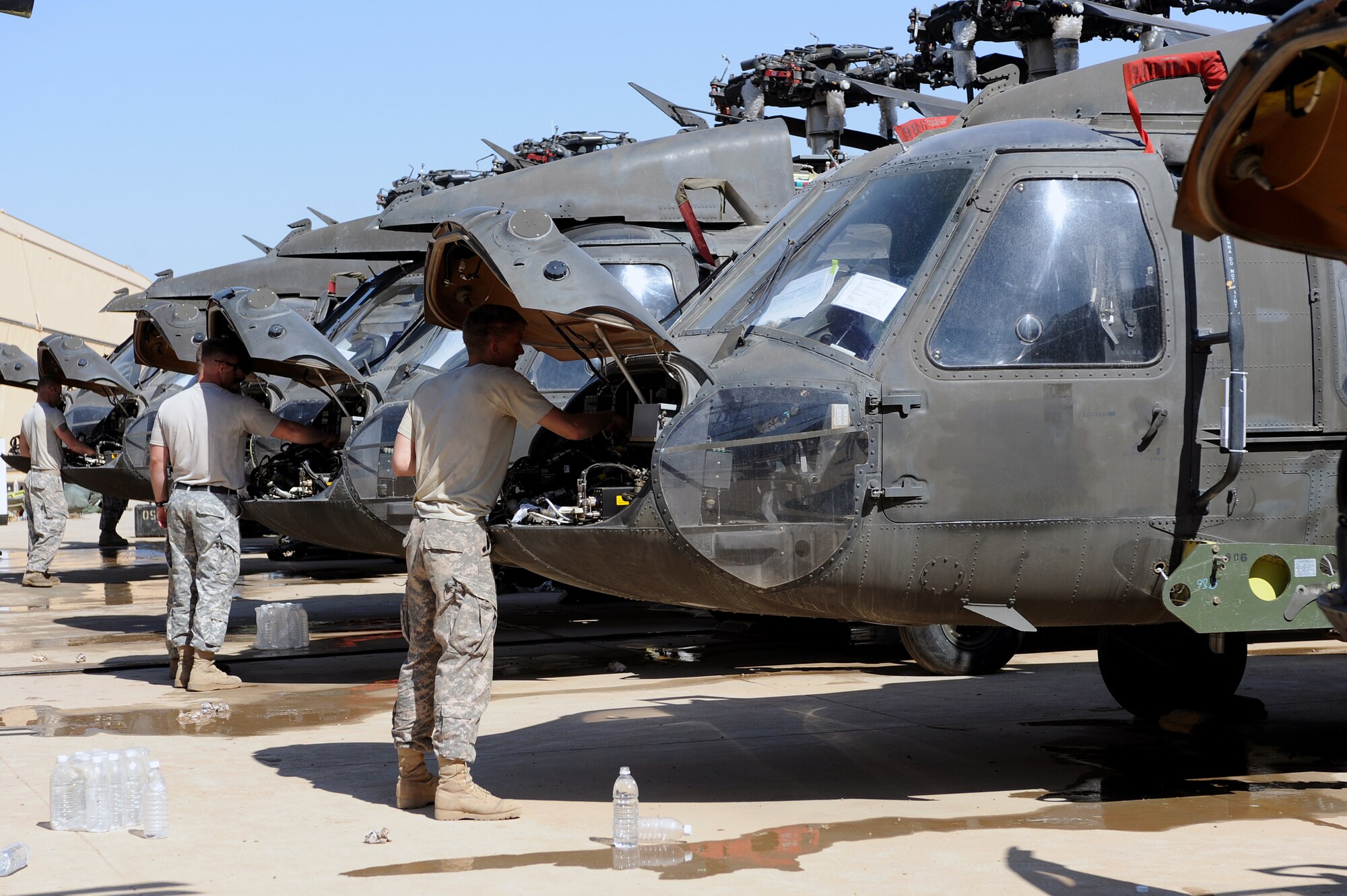 Soldiers clean under the hoods of UH-60 Black Hawk's in preparation for inspection at Joint Base Balad, Iraq, April 15, 2010. Navy Customs personnel inspected 28 helicopters consisting of AH-64 Apaches, CH-47 Chinooks and Black Hawks, to ensure they are clean and contain authorized equipment. The helicopters arrived from forward operating bases throughout Iraq and are being prepared for redeployment back to the United States. (U.S. Air Force photo by Master Sgt. Linda C. Miller/Released)  