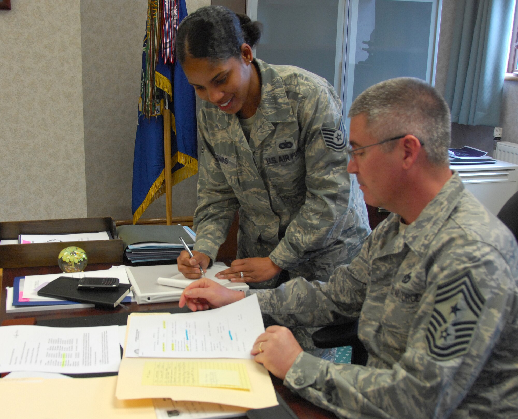 Tech. Sgt. Kimberly Thomas, 48th Fighter Wing Executive Assistant to the Command Chief works closely with Chief Master Sgt. James Lucas, 48th Fighter Wing Command Chief on a variety of issues that affect personnel on RAF Lakenheath April 20. Sergeant Thomas was nominated for a liberty spotlight because she displays 'Integrity First'.(U.S. Air Force photo/Tech. Sgt. Christopher Campbell)