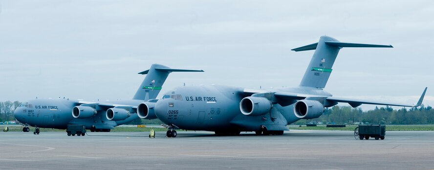 The AIr Force's oldest, right and newest C-17 Globemaster III's grace the flightline at McChord Field April 22.  The aircraft on the right was the first production model C-17 to come off the assembly line in 1993, originally delivered to Charleston Air Force Base, SC.  The delivery of the newest C-17 here brings McChord Field's total aircraft count to 51.  (U.S. Air Force Graphic/Abner Guzman)