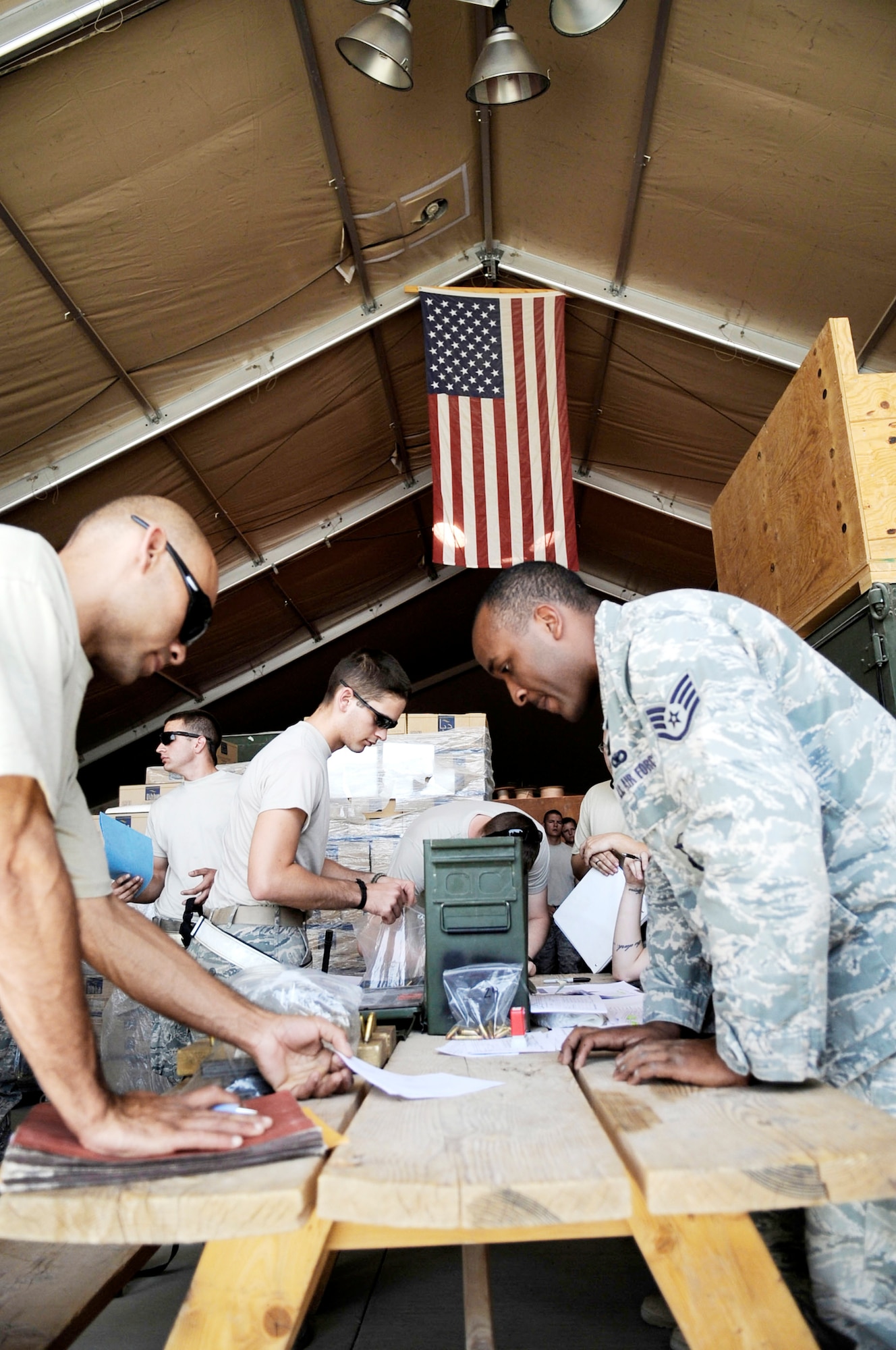 Staff Sgt. Chanson Johnson reviews a hand receipt to ensure redeploying members of the 451st Expeditionary Aircraft Maintenance Squadron have properly listed all items being turned in April 16, 2010, at Kandahar Airfield, Afghanistan. Sergeant Johnson is the 451st Expeditionary Security Forces Squadron combat arms NCO in charge. (U.S. Air Force photo/Senior Airman Nancy Hooks)