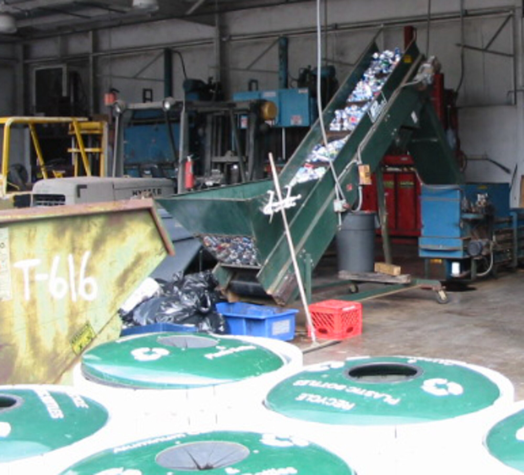 Hundreds of aluminum cans are processed on a conveyor belt in this file photo from the Hurlburt Field recycle center. The base recycled more than 160,000 pounds of metals, papers, glass, and plastics during the first two quarters of fiscal year 2010. (Courtesy photo)