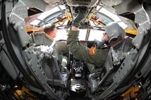 MINOT AIR FORCE BASE, N.D. – Capt. David Lane and 1st Lt. Michael Perry, both pilots with the 23rd Bomb Squadron, perform their preflight checks before taking off in a B-52H Stratofortress here April 20. Captain Lane and Lieutenant Perry were part of an eight-man crew preparing for a nine-hour training flight. (U.S. Air Force photo by Staff Sgt. Stacy Moless)