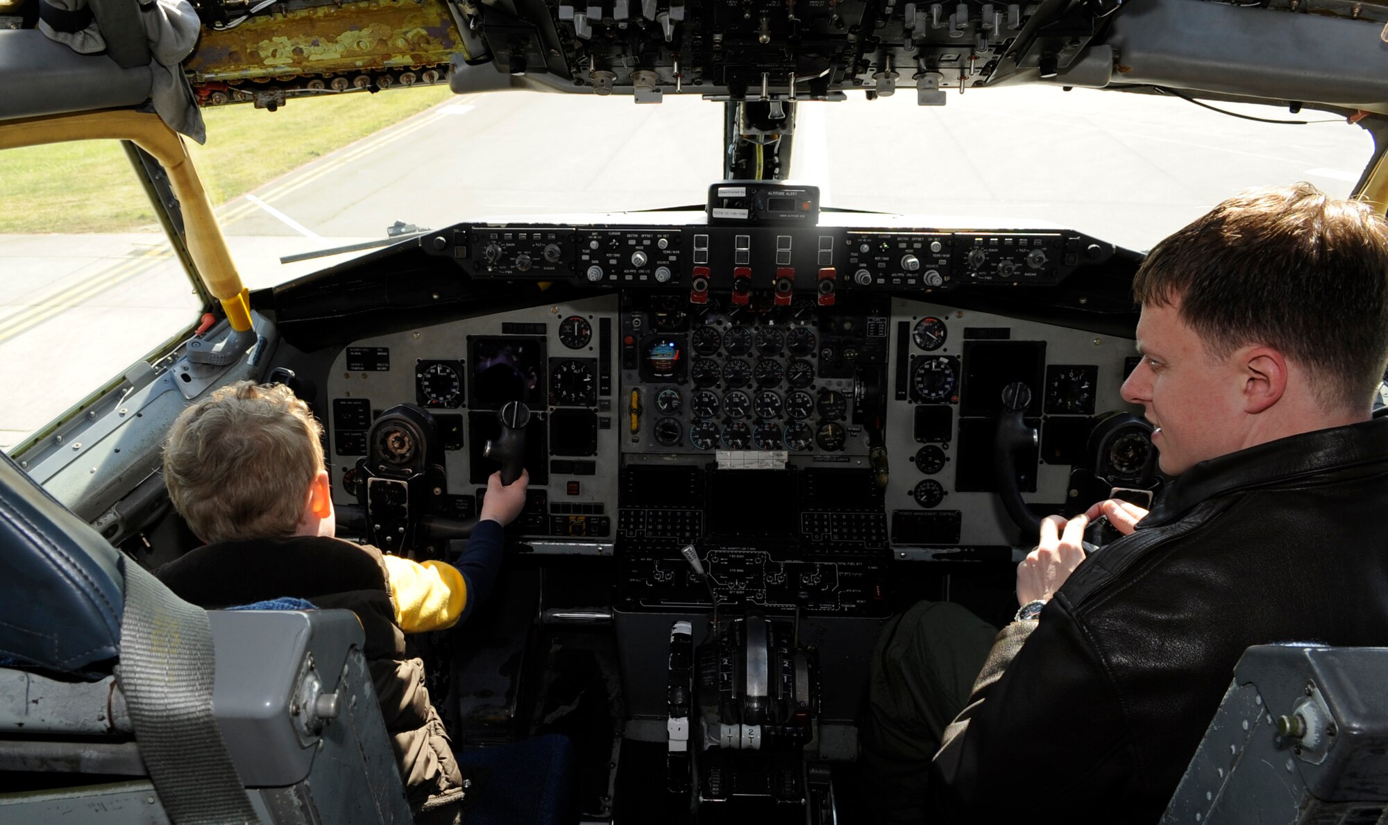 RAF MILDENHALL, England – Capt. Joshua Chambers, 100th Air Refueling Wing, and his son Hayden get behind the stick of a KC-135 Stratotanker April 22.  The static display gave children the chance to explore the aircraft as part of “Bring Your Child to Work Day.”  (U.S. Air Force photo/Staff Sgt. Christopher L. Ingersoll)