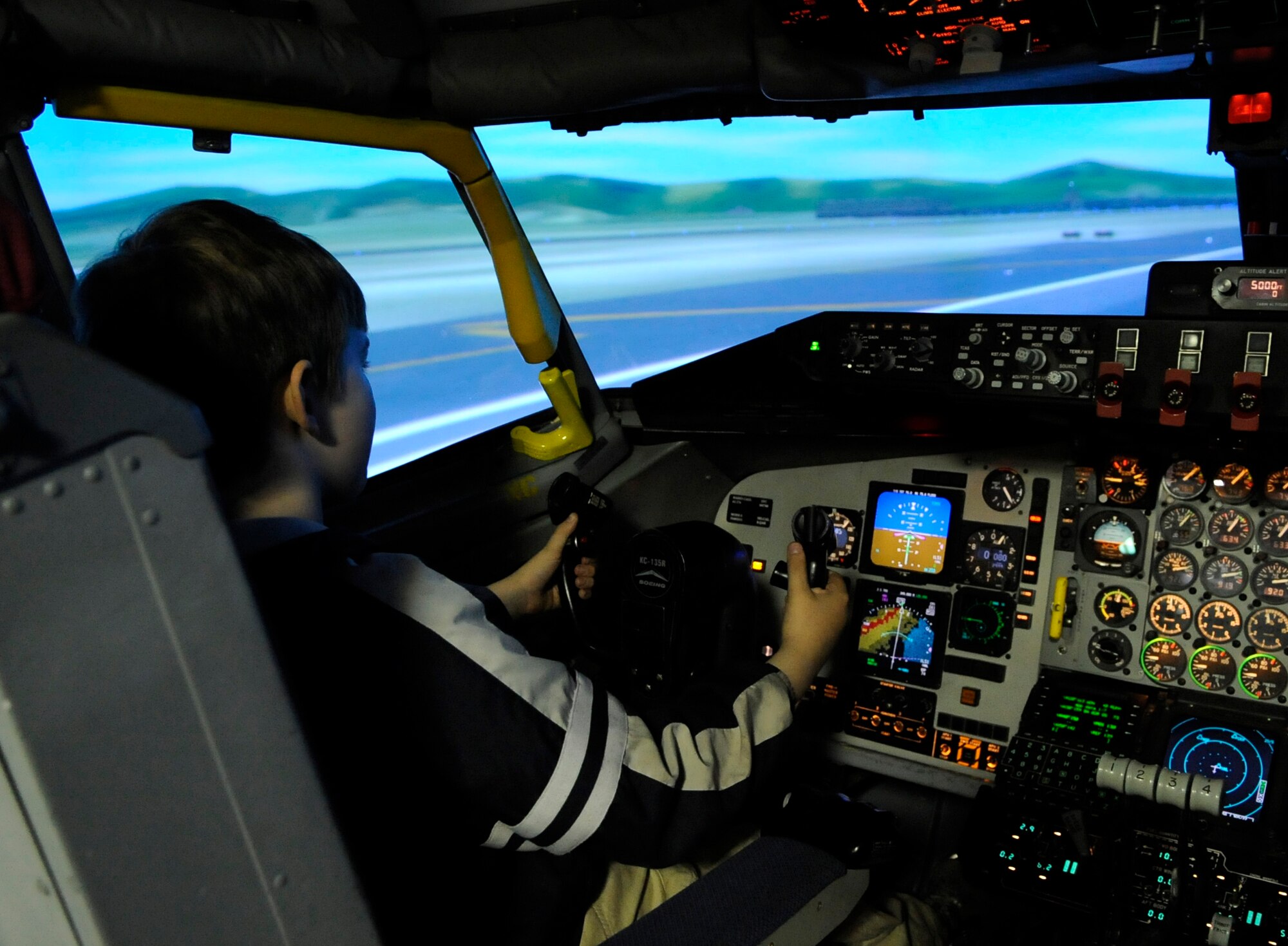 RAF MILDENHALL, England – Devon Milstead pilots a KC-135 Stratotanker simulator during “Bring Your Kids to Work Day” April 22.  Devon was one of several children who visited the base to see what their parents do at work and to see demonstrations of military equipment.  (U.S. Air Force photo/Staff Sgt. Christopher L. Ingersoll)