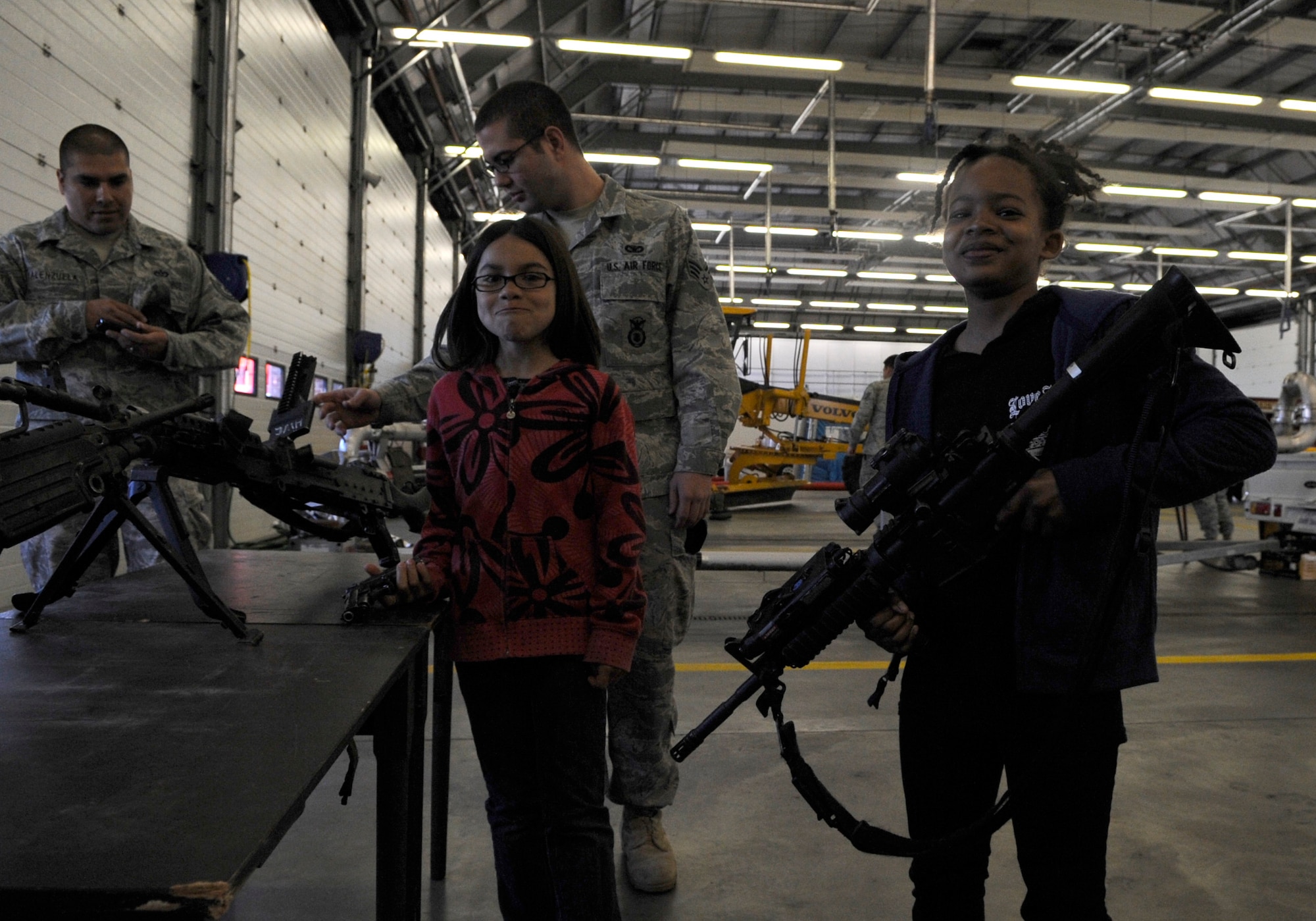 RAF MILDENHALL, England – Ahrianna Reed shows her “war face” while feeling the weight of a rifle during “Bring Your Child to Work Day” April 22.  The event saw dozens of children experiencing their parent’s day-to-day life in the Air Force.  (U.S. Air Force photo/Staff Sgt. Christopher L. Ingersoll)