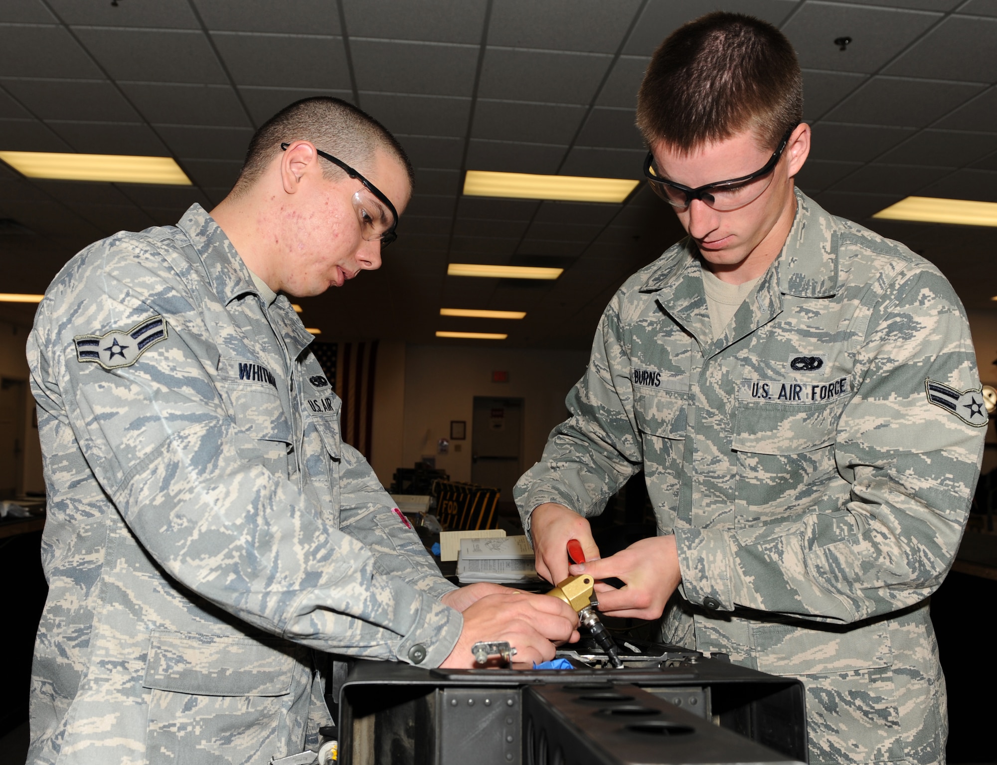 SEYMOUR JOHNSON AIR FORCE BASE, N.C. -- Airmen 1st Class Travis Whitman and Benjamin Burns perform a 36-month egress inspection here April 20, 2010. During the inspection, egress units are stripped down, inspected, and fixed, refurbished or rebuilt if need be. Airman Whitman and Airman Burns are both 4th Component Maintenance Squadron egress technicians. Airman Whitman is from South Gate, Mich. and Airman Burns is from Hershey, Pa. (U.S. Air Force photo/Airman 1st Class Gino Reyes)
