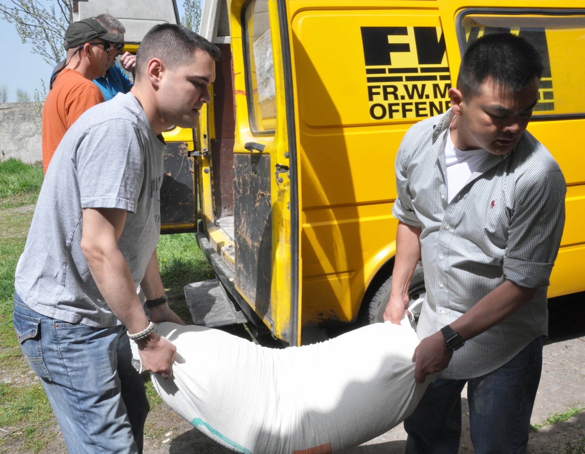 Staff Sgt. Ryan Rubino and Capt. Tom Mulka unload flour and other dry goods for the Orto-Suiskaya Boarding School/orphanage for children with mental disabilities April 22, 2010. Humanitarian assistance is an important focus for Airmen from the Transit Center. (U.S. Air Force photo/Staff Sgt. Carolyn Viss)