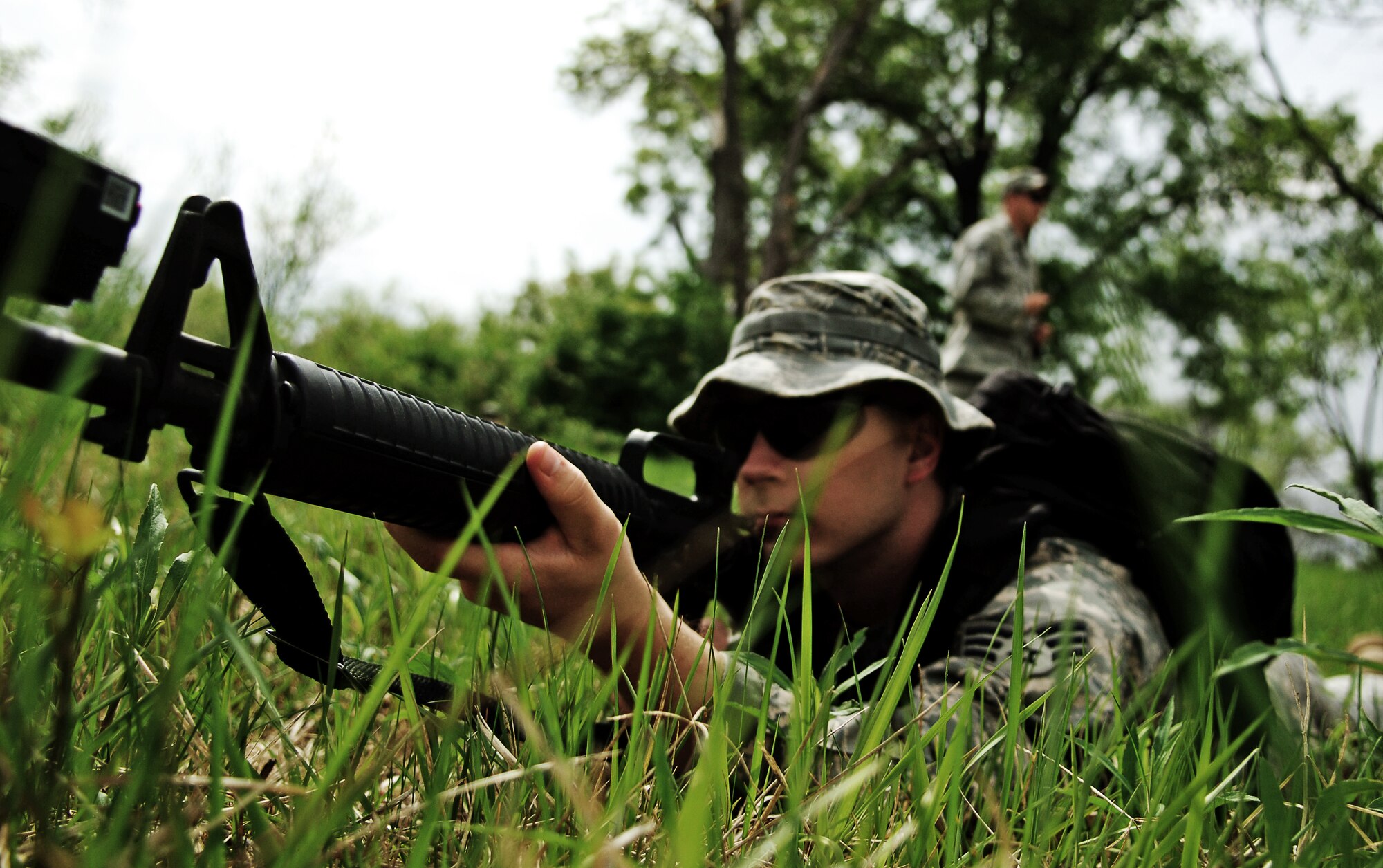 SCOTT AIR FORCE BASE, Ill. -- Senior Airman Ralph Ross, 15th OWS weather forecaster, lays in the prone position with his M-16 rifle after a simulated ambush. Weather forecasters come to the 15th OWS after completing their technical school to get further hands on training that they will use in the field.  Because many of the Airmen will be deployed in support of the Army, they go through tactical combat training to better prepare them. (U.S. Air Force photo by Senior Airman Ryan Crane)
