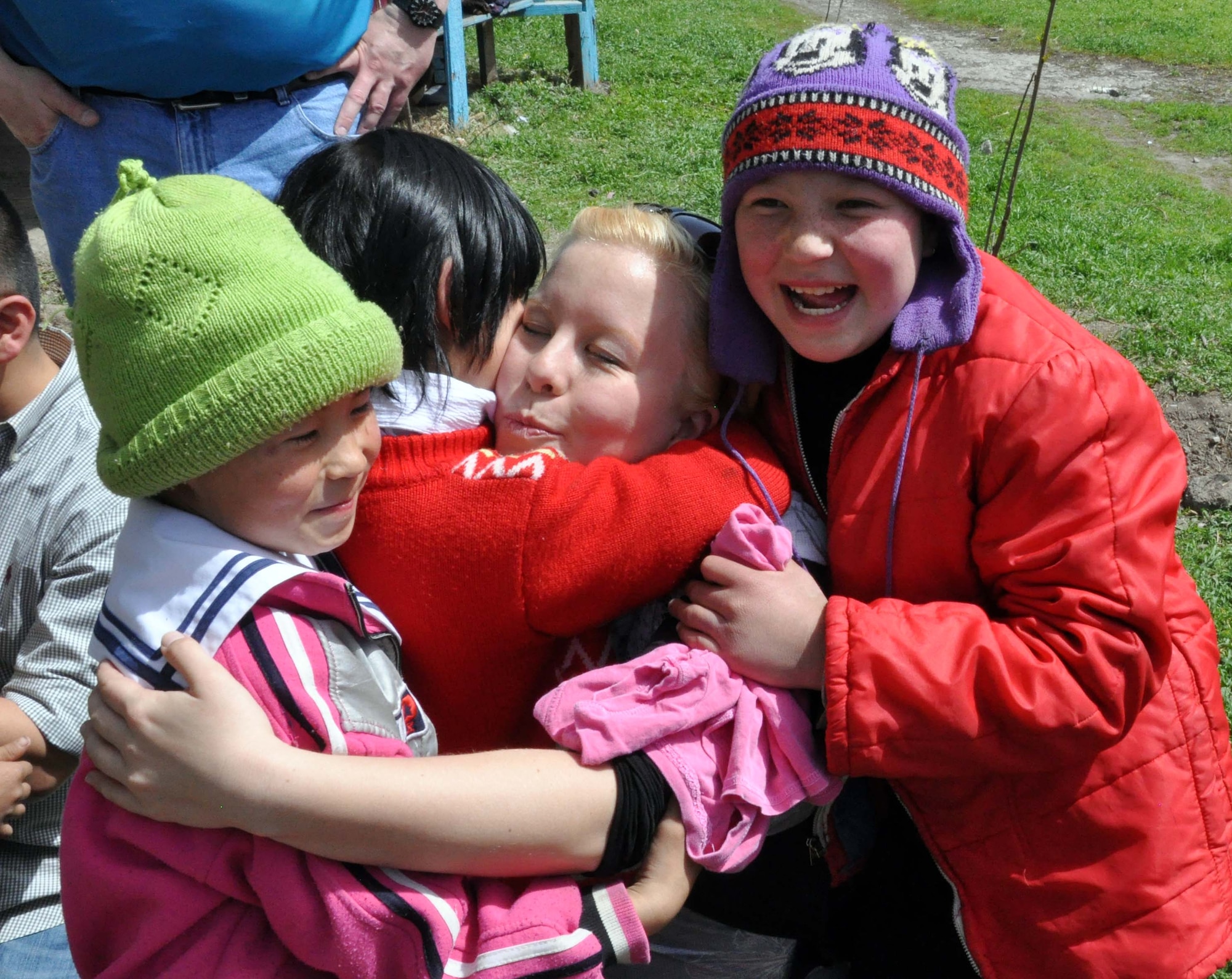 Staff Sgt. Carolyn Viss, an Airman from the Transit Center at Manas, hugs three Kyrgyz girls from the Orto-Suiskaya Boarding School/orphanage April 22, 2010, during a humanitarian assistance visit to the school, which hosts 180 mentally handicapped children. Airmen delivered food and clothing to the residents there as a part of their ongoing humanitarian assistance mission. (U.S. Air Force photo/Staff Sgt. Don Tipton Jr.)