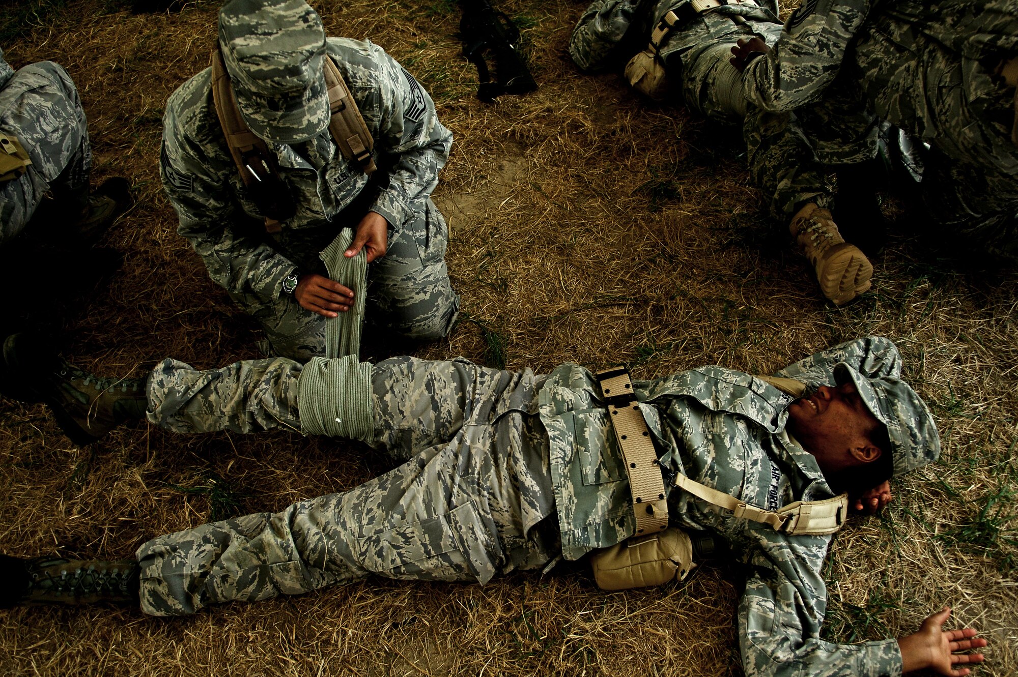 SCOTT AIR FORCE BASE, Ill. -- Forecasters from the 15th OWS practice Self Aid and Buddy Care techniques during the exercise. Weather forecasters come to the 15th OWS after completing their technical school to get further hands on training that they will use in the field.  Because many of the Airmen will be deployed in support of the Army, they go through tactical combat training to better prepare them. (U.S. Air Force photo by Senior Airman Ryan Crane)
