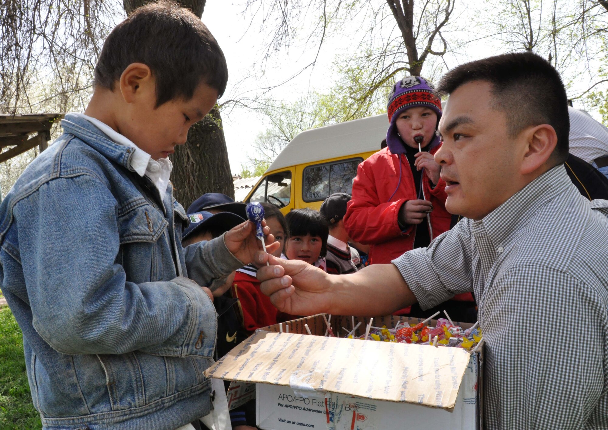Capt. Tom Mulka, the Manas Area Benefit Outreach Society president, hands a child from the Orto-Suiskaya Boarding School/orphanage a lollipop during a humanitarian assistance visit April 22, 2010. Airmen from the Transit Center at Manas delivered food and clothing to the mentally handicapped residents there. (U.S. Air Force photo/Staff Sgt. Carolyn Viss)