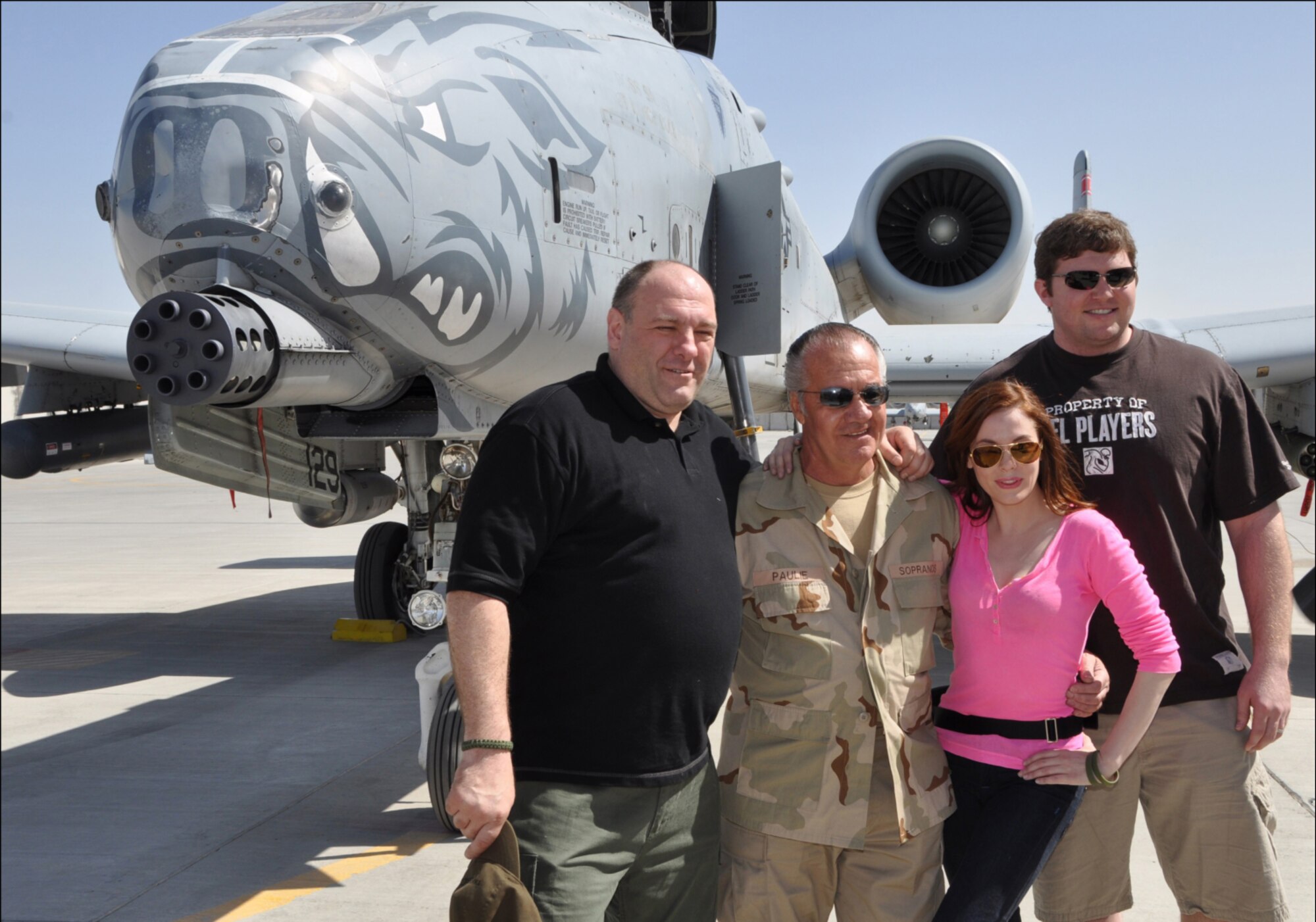 Actors from the HBO show "The Sopranos," James Gandolfini and Tony Sirico, Rose McGowan from the television series "Charmed" and Jon Stinchcomb, starting offensive tackle for the 2010 Super Bowl Champion New Orleans Saints, pose for a photo in front of a 188th Fighter Wing A-10C Thunderbolt II "Warthog" at Kandahar Airfield, Afghanistan, March 30 as part of a USO tour of bases in Afghanistan. (U.S. Air Force photo by Lt. Col. Keith Moore/Arkansas Air National Guard Public Affairs officer)