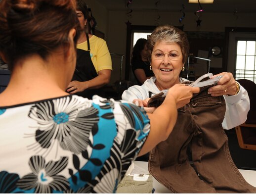 SEYMOUR JOHNSON AIR FORCE BASE, N.C. -- Maria Tarraza consigns a pair of pants to Sue Keesling in the Thrift Shop here, April 20, 2010. Consignment items are sold by the Thrift Shop for a 25 percent profit which goes toward base and local community programs. Ms. Tarraza is a native of Rockville, Md., and Ms. Keesling hails from Roanoke, Va.  (U.S. Air Force photo/Senior Airman Whitney Lambert) 