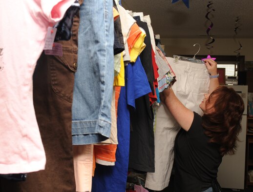 SEYMOUR JOHNSON AIR FORCE BASE, N.C. -- Kaitlyn Matthiessen hangs clothing to be priced in the Thrift Shop here, April 20, 2010. Through donations and consignments, the Thrift Shop receives more than 200 clothing items weekly. Ms. Matthiessen hails from Seattle. (U.S. Air Force photo/Senior Airman Whitney Lambert)