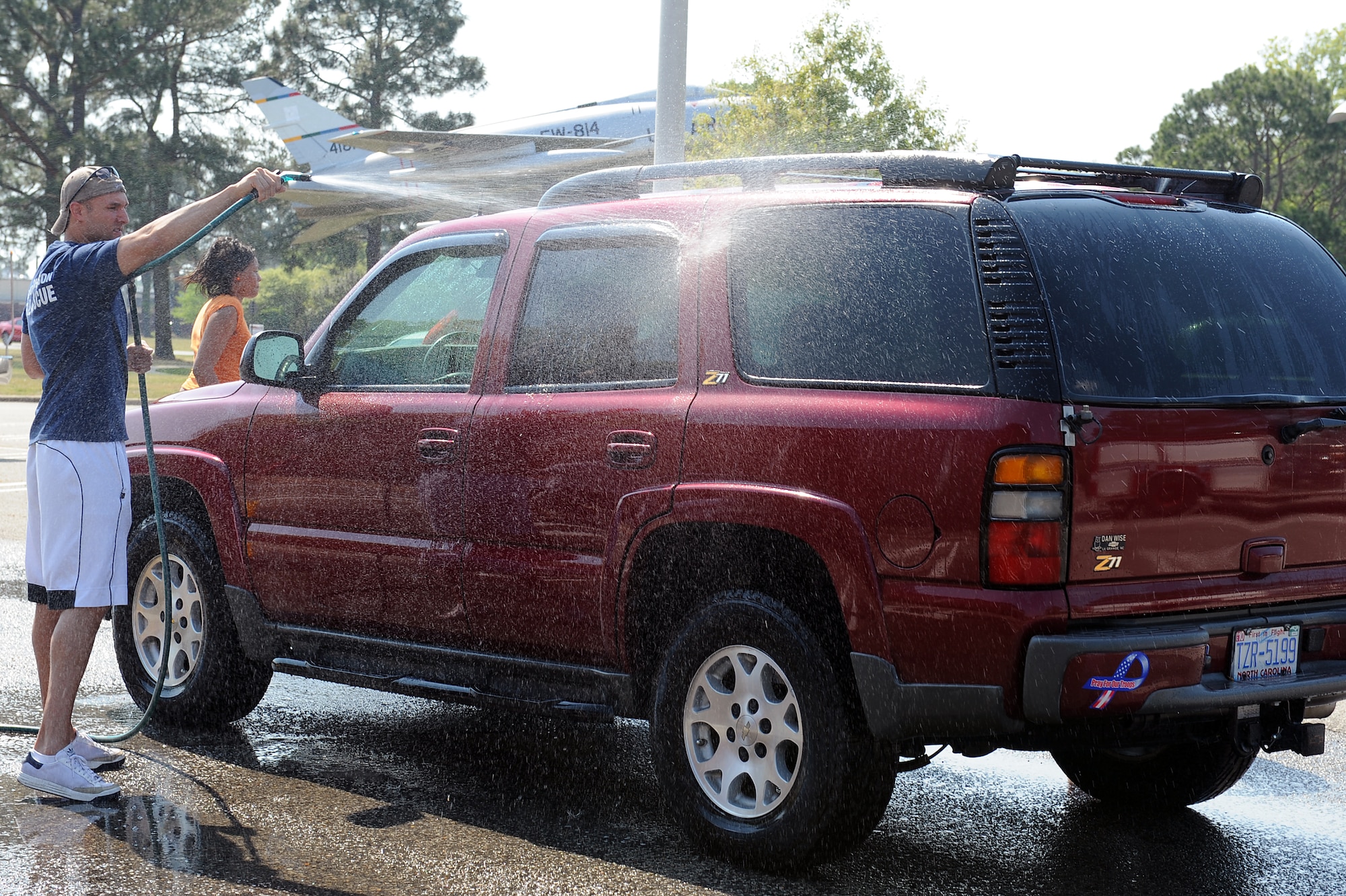 SEYMOUR JOHNSON AIR FORCE BASE, N.C. -- Airman 1st Class Aaron Shields rinses off a vehicle at a car wash here April 16, 2010. Base firefighters volunteered to wash cars to raise money for Wayne Action Teams for Community Health, a program committed to the well being of citizens in the Wayne County community. Airman Shields is a firefighter with the 4th Civil Engineer Squadron and is from Cedar Rapids, Iowa. (U.S. Air Force photo/Senior Airman Whitney Lambert)  