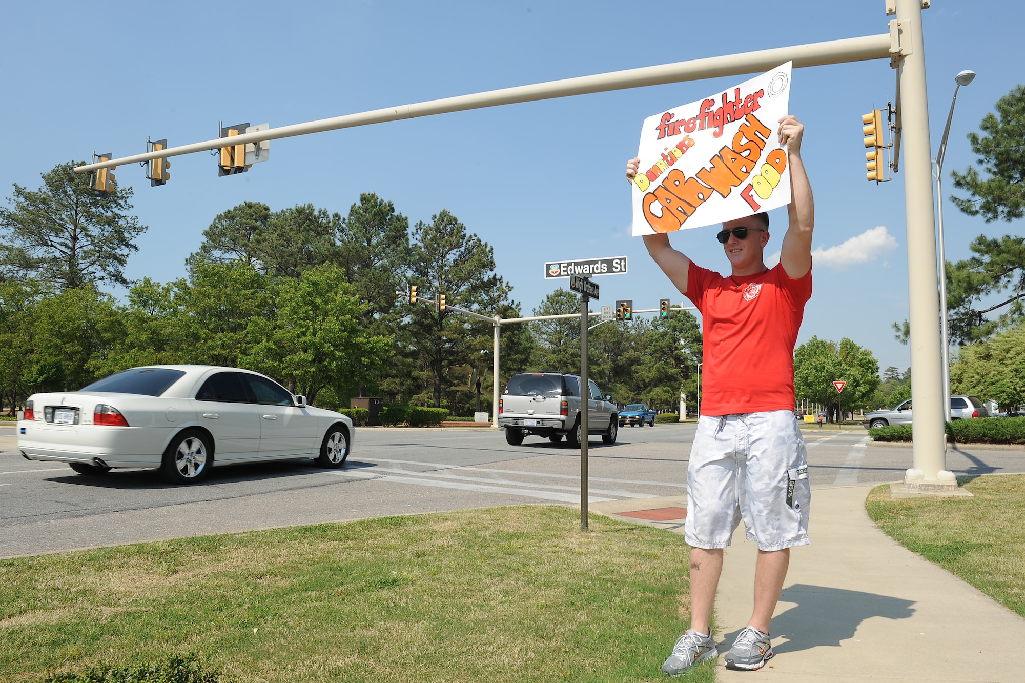 SEYMOUR JOHNSON AIR FORCE BASE, N.C. -- Airman 1st Class Brian Davenport holds a sign showing a donation-only car wash being held here April 16, 2010. The carwash raised money for Wayne Action Teams for Community Health. WATCH is a program designed to improve and educate our community on health and wellness issues. Airman Davenport is a firefighter with the 4th Civil Engineer Squadron and hails from Tampa, Fla. (U.S. Air Force photo/Senior Airman Ciara Wymbs)