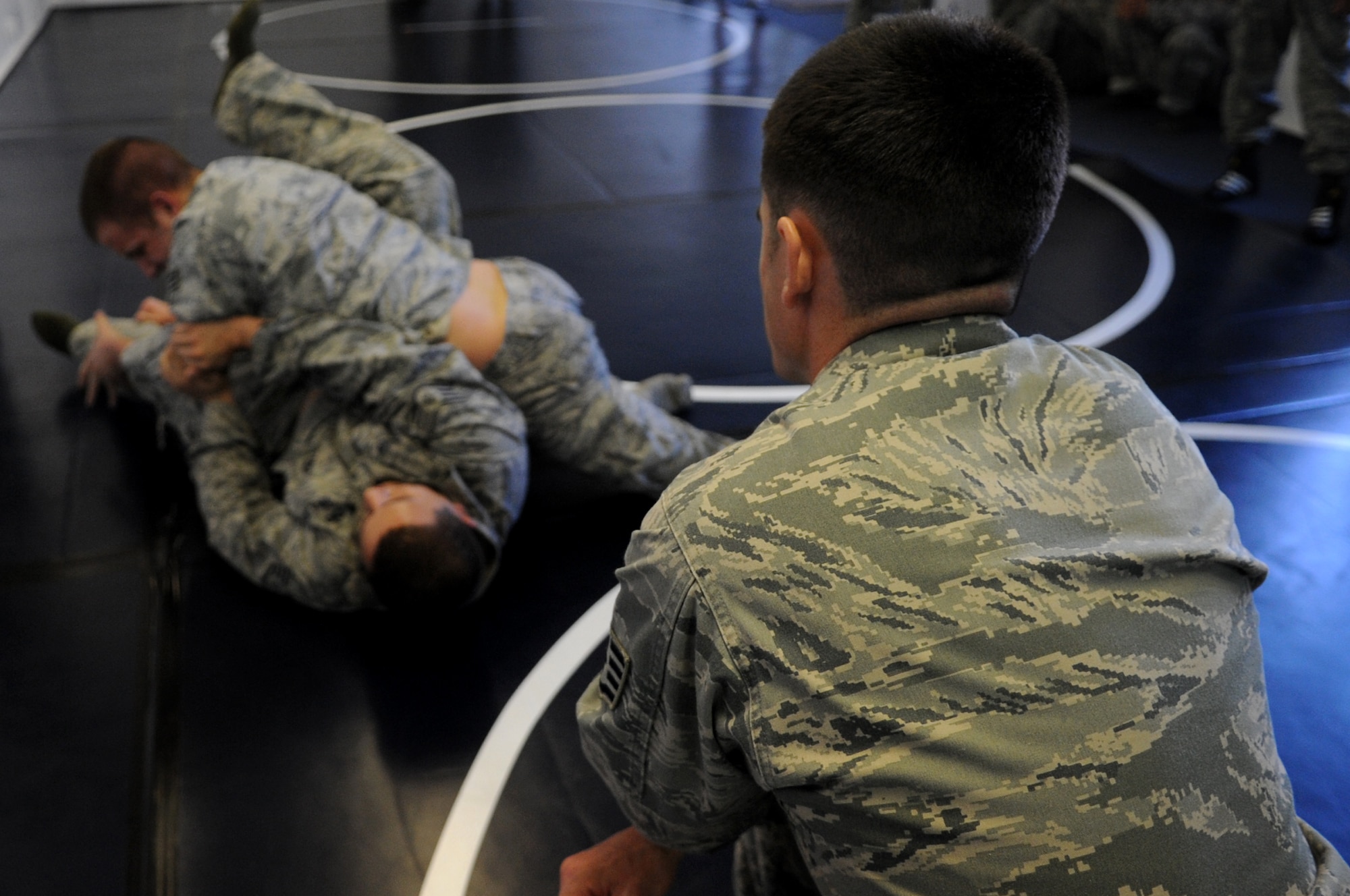 U.S. Air Force Staff Sgt. Darin Morrison, 435th Security Forces Squadron creek defender instructor, observes as two Airmen use their modified army combative technique during a practice session, Sembach Annex, Germany, April 21, 2010. The army combative course was part of Unites States Air Forces in Europe's first ever Fly Away Security Team class. (U.S. Air Force photo by Airman 1st Class Grovert Fuentes-Contreras)
