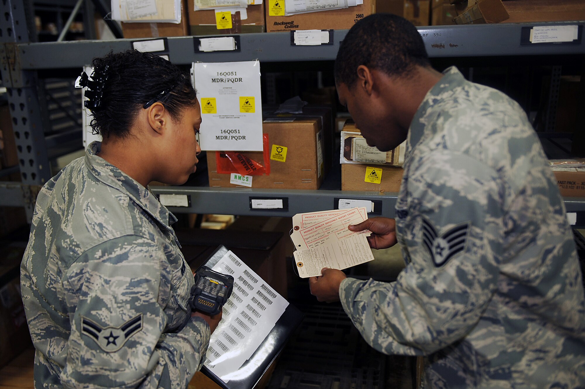 SEYMOUR JOHNSON AIR FORCE BASE, N.C. -- Staff Sgt. Markeith Jackson explains what to look for on a quality deficiency report to Airman 1st Class Erica Winfield at the aircraft parts store here April 20, 2010. These reports show items that have discrepancies such as missing or broken parts that may need replacing or repairs. Sergeant Jackson and Airman Winfield are both 4th Logistics Readiness Squadron APS technicians. Sergeant Jackson is from Los Angeles and Airman Winfield is from Norfolk, Va. (U.S. Air Force photo/Senior Airman Ciara Wymbs) 