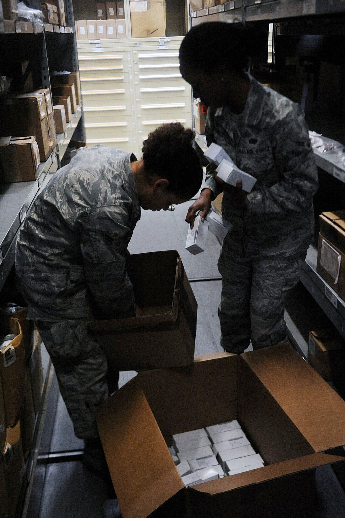 SEYMOUR JOHNSON AIR FORCE BASE, N.C. -- Airmen 1st Class Renee Lane and Britani Mikell stock parts at the aircraft parts store here April 20, 2010. Placing parts in their correct location and ensuring accountability is vital to the organization of the facility. Airmen Lane and Mikell are APS technicians with the 4th Logistics Readiness Squadron. Airman Lane is from Reno, Nev., and Airman Mikell hails from Virginia Beach, Va. (U.S. Air Force photo/Senior Airman Ciara Wymbs) 
