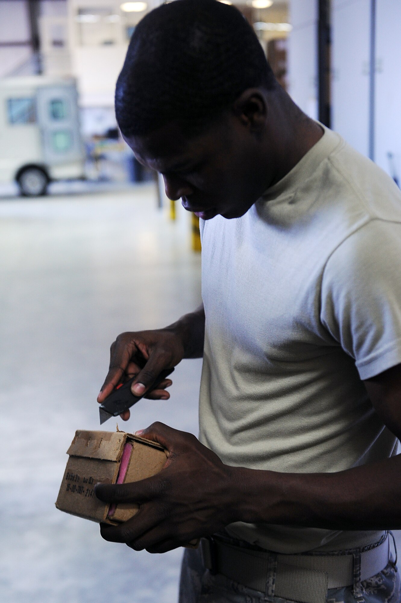 SEYMOUR JOHNSON AIR FORCE BASE, N.C.-- Airman 1st Class Curtis Thomas sanitizes boxes at the aircraft parts store here April 20, 2010. Sanitizing boxes and packages includes removing labels and any information not required for storage. Airman Thomas is an APS technician with the 4th Logistics Readiness Squadron and hails from West Helena, Ark. (U.S. Air Force photo/Senior Airman Ciara Wymbs) 