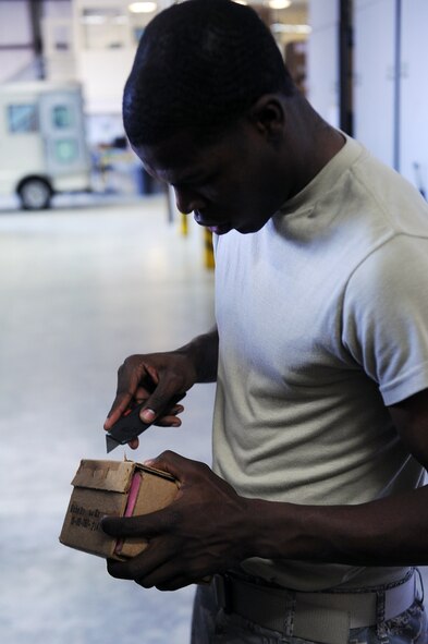SEYMOUR JOHNSON AIR FORCE BASE, N.C.-- Airman 1st Class Curtis Thomas sanitizes boxes at the aircraft parts store here April 20, 2010. Sanitizing boxes and packages includes removing labels and any information not required for storage. Airman Thomas is an APS technician with the 4th Logistics Readiness Squadron and hails from West Helena, Ark. (U.S. Air Force photo/Senior Airman Ciara Wymbs) 
