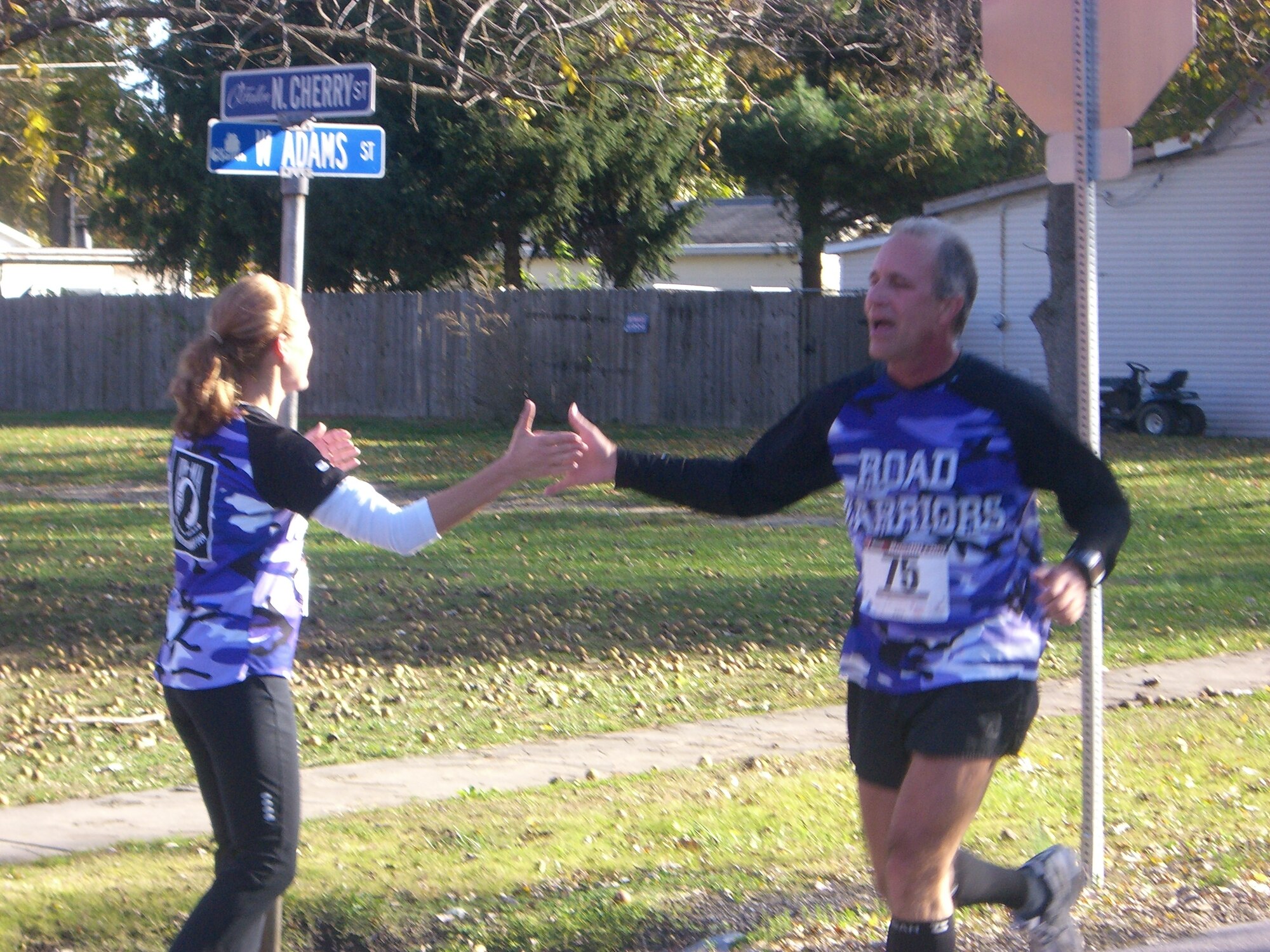 SCOTT AIR FORCE BASE, Ill. -- Brian Trout, 618th TACC, high-fives Tami Spellman during a race in O’Fallon.  They’re part of the Road Warriors fitness group, formed to promote fitness as a lifestyle. (Courtesy Photo)
