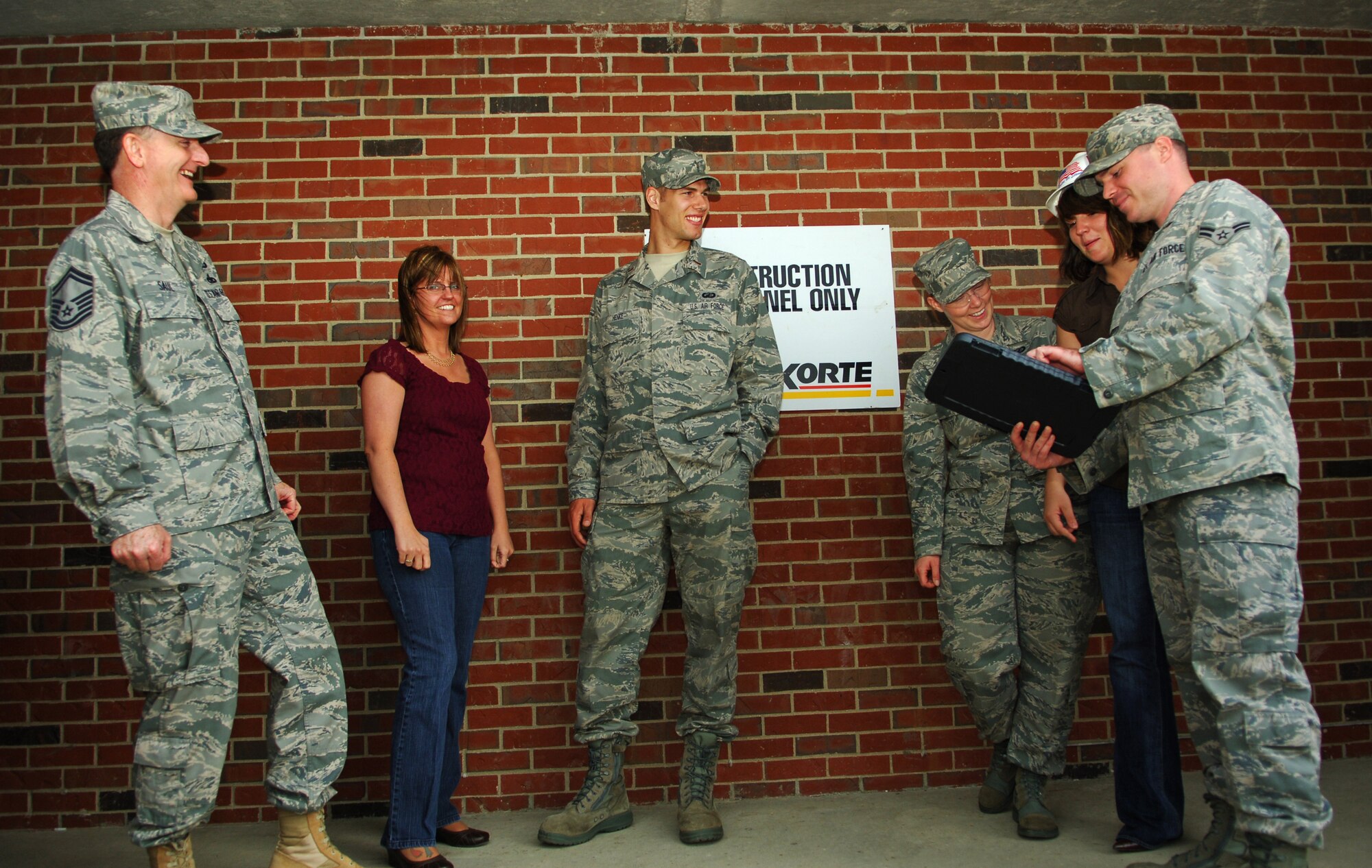 SCOTT AIR FORCE BASE, Ill. -- Members of the 375th Contracting Squadron gather near a renovation project at the Belleville Dorms.  The Contracting Squadron is responsible for the acquisition of the goods, services and construction necessary to sustain Scott’s operational ground capabilities.(U.S. Air Force photo by Senior Airman Ryan Crane)
