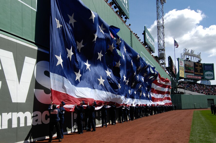 BOSTON – Airmen from Hanscom Air Force Base gather the flag after Patriot’s Day activities at Fenway Park on April 19.  (U.S. Air Force photo by Rick Berry)