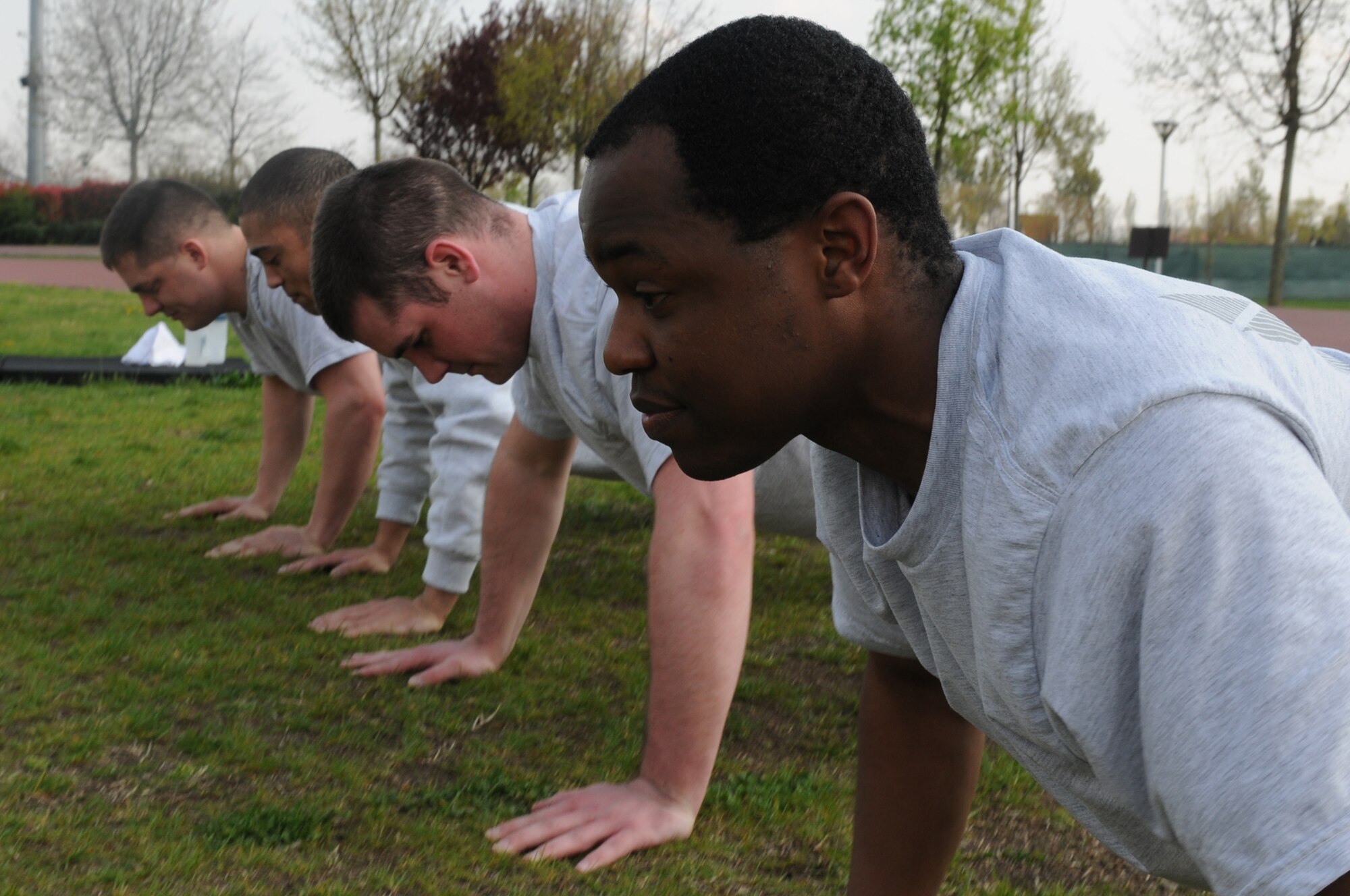 Airmen from the 31st Maintenance Squadron Precision Measurement Equipment Laboratory Flight perform pushups during a group physical training session April 15. (U.S. Air Force photo/ Staff Sgt. Nadine Y. Barclay)