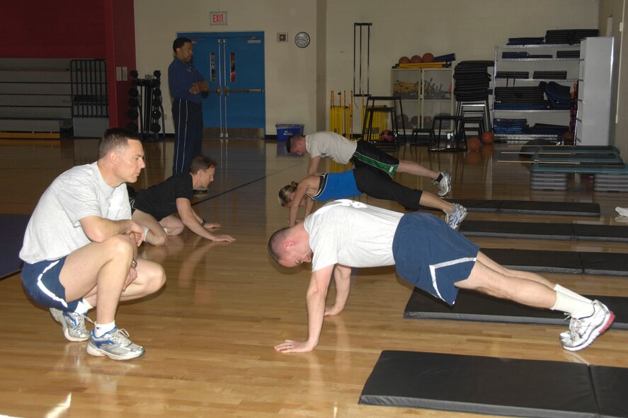 HANSCOM AIR FORCE BASE, Mass – Participants of the Wing Fit Challenge do pushups as others encourage them at the Fitness Center on May 14. Participants were evaluated on body composition, pushups, sit ups, a 5K run and flexibility. The 66th Medical Group won the event and 554th Electronic Systems Wing came in second. (U.S. Air Force photo by Linda LaBonte Britt)