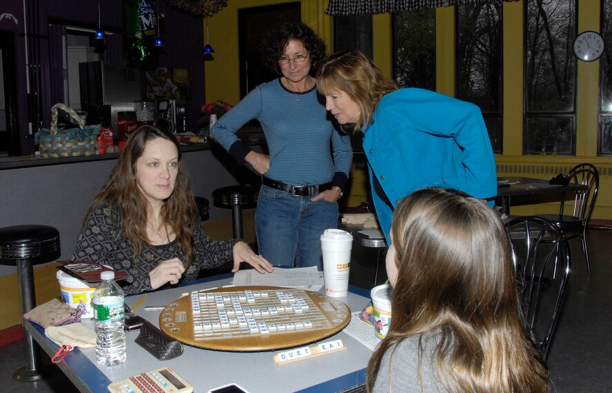 HANSCOM AIR FORCE BASE, Mass – Michelle O’Brien (l), takes on Kimberly Nevins in a game of Scrabble as Laura Pearlstein (second from l) and Ruth Weiner observe. The Scrabble Tournament took place on April 17 at the Youth Center. (U.S. Air Force photo by Linda LaBonte Britt)
