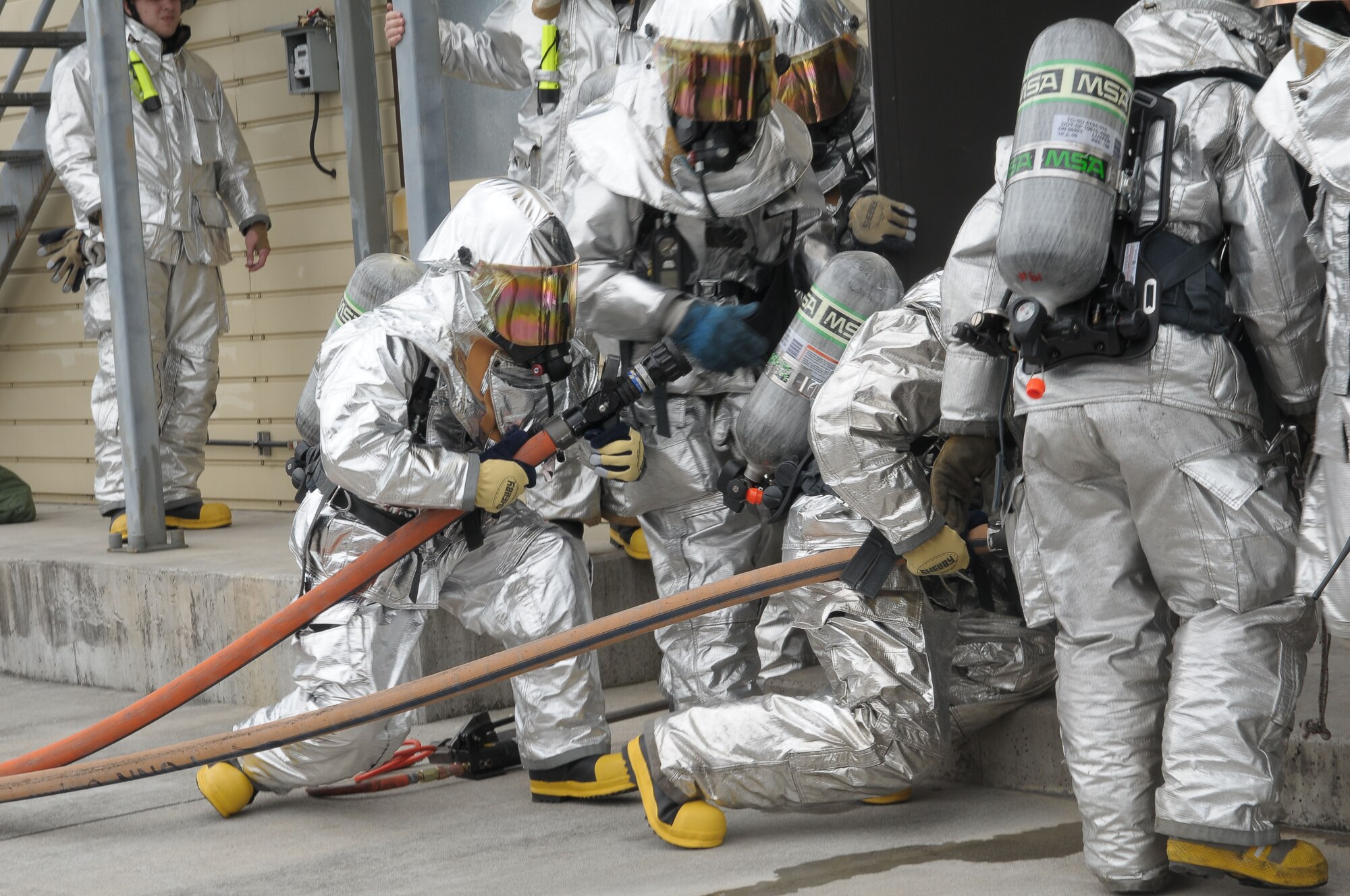 YOKOTA AIR BASE, Japan -- Col. Mark Hicks, 374th Airlift Wing commander, prepares to enter a burning building April 20 during a live fire training exercise. This was the first time that wing leadership had participated in this type of exercise. (U.S. Air Force photo/Airman 1st Class Sean Martin)