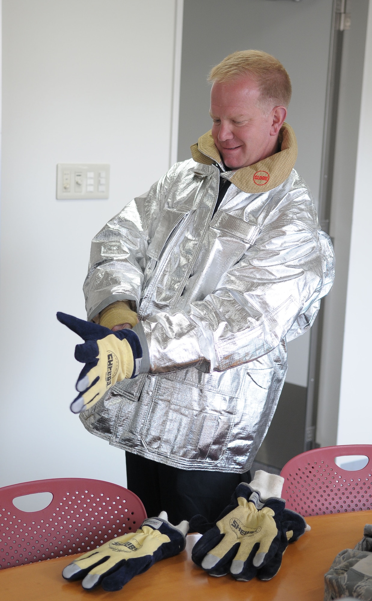 YOKOTA AIR BASE, Japan -- Col. Mark Hicks, 374th Airlift Wing commander, puts on his Personal Protective Equipment April 20 during a live fire training exercise. (U.S. Air Force photo/Airman 1st Class Sean Martin)