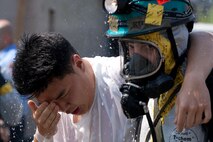NEW YORK -- A FDNY firefighter sprays water on simulated victims of a chemical attack in the subway, as Marines from the Chemical Biological Incident Response Force (CBIRF) lead them out of the subway, at FDNY Fire Academy on Randall's Island, N.Y, April 22. FDNY and Marines from the Chemical Biological Incident Response Force (CBIRF) joined together for a training exercise after a weeklong training evolution between the two units.  (Official Marine Corps photo by Sgt. Randall A. Clinton / RELEASED)
