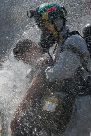 NEW YORK -- A FDNY firefighter sprays water on simulated victims of a chemical attack in the subway, as Marines from the Chemical Biological Incident Response Force (CBIRF) lead them out of the subway, at FDNY Fire Academy on Randall's Island, N.Y, April 22. FDNY and Marines from the Chemical Biological Incident Response Force (CBIRF) joined together for a training exercise after a weeklong training evolution between the two units.  (Official Marine Corps photo by Sgt. Randall A. Clinton / RELEASED)