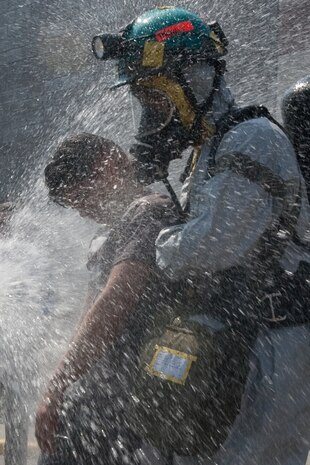 NEW YORK -- A FDNY firefighter sprays water on simulated victims of a chemical attack in the subway, as Marines from the Chemical Biological Incident Response Force (CBIRF) lead them out of the subway, at FDNY Fire Academy on Randall's Island, N.Y, April 22. FDNY and Marines from the Chemical Biological Incident Response Force (CBIRF) joined together for a training exercise after a weeklong training evolution between the two units.  (Official Marine Corps photo by Sgt. Randall A. Clinton / RELEASED)