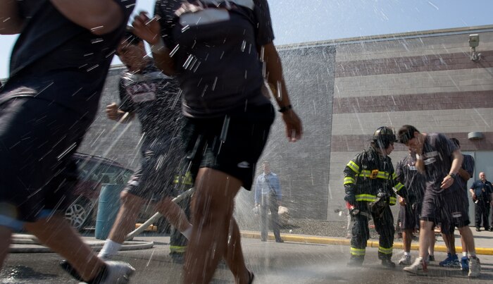 NEW YORK -- A FDNY firefighter sprays water on simulated victims of a chemical attack in the subway, as Marines from the Chemical Biological Incident Response Force (CBIRF) lead them out of the subway, at FDNY Fire Academy on Randall's Island, N.Y, April 22. FDNY and Marines from the Chemical Biological Incident Response Force (CBIRF) joined together for a training exercise after a weeklong training evolution between the two units.  (Official Marine Corps photo by Sgt. Randall A. Clinton / RELEASED)