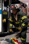 NEW YORK -- A FDNY firefighter races to help victims during a simulated bus bombing, at FDNY Fire Academy on Randall's Island, N.Y, April 22. FDNY and Marines from the Chemical Biological Incident Response Force (CBIRF) joined together for a training exercise after a weeklong training evolution between the two units.  (Official Marine Corps photo by Sgt. Randall A. Clinton / RELEASED)