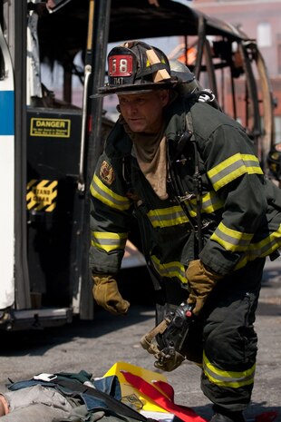 NEW YORK -- A FDNY firefighter races to help victims during a simulated bus bombing, at FDNY Fire Academy on Randall's Island, N.Y, April 22. FDNY and Marines from the Chemical Biological Incident Response Force (CBIRF) joined together for a training exercise after a weeklong training evolution between the two units.  (Official Marine Corps photo by Sgt. Randall A. Clinton / RELEASED)