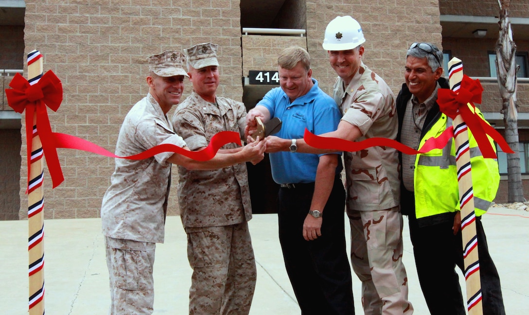 (Left to right) Col. Nicholas F. Marano, commanding officer, Marine Corps Base Camp Pendleton; Lt. Col. Scott D. Leonard, commanding officer, 1st Light Armored Reconnaissance Battalion; Patrick B. Walls, senior project manager, Stronghold Engineering Inc.; Lt. Cmdr. Scott King, resident officer in charge of construction, MCB Camp Pendleton; David R. Mendoza, project superintendent, Stronghold Engineering Inc., cut the ribbon for Camp Pendleton’s newest barracks in the 41 Area on earth day. The $9.7 million facility is the second building on base to be powered via solar powered electricity, and can house up to 288 service members.