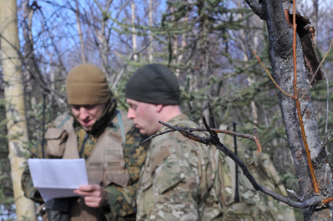 Air Force Staff Sgt. Brooks Steinbacher, right, 353rd Combat Training Squadron survival, evasion, resistance and escape instructor, advises Capt. Kevin Smalley, Marine Attack Squadron 211 pilot, on his next course of action during SERE training at the Joint Pacific Alaskan Range Complex in Alaska April 22, 2010.