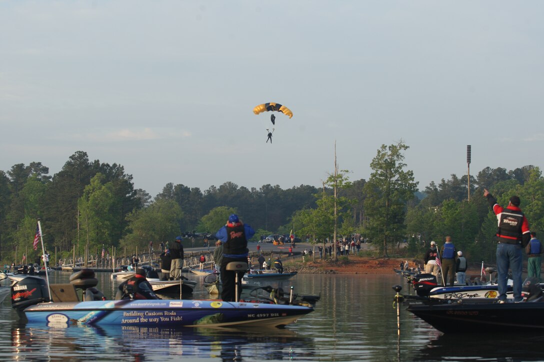 A member of the U.S. Army parachute team The Golden Knights prepares to touch down during the opening ceremony of the 2010 Warriors on the Water Bass Fishing Tournament held at Lake Jordan in Raleigh, N.C., April 23. After a day of scoping out hot spots on the lake, service members and civilian boaters competed for the largest bass fish.