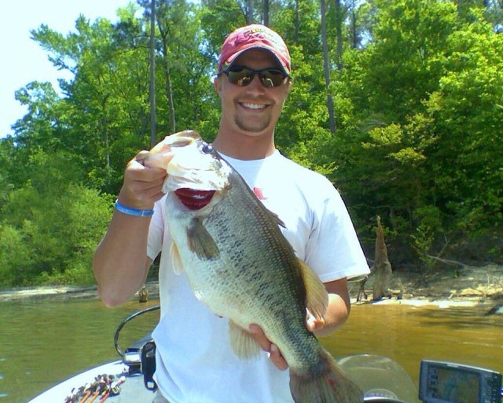 Andrew Young, a professional angler from Clarendon, N.C., holds an eight and a half pound bass during the 2010 Warriors on the Water Bass Fishing Tournament held at Lake Jordan in Raleigh, N.C., April 23. The WOW tournament, a military appreciation event, is free to all branches of the Department of Defense where service members and civilian boaters come together to swap stories and catch fish.