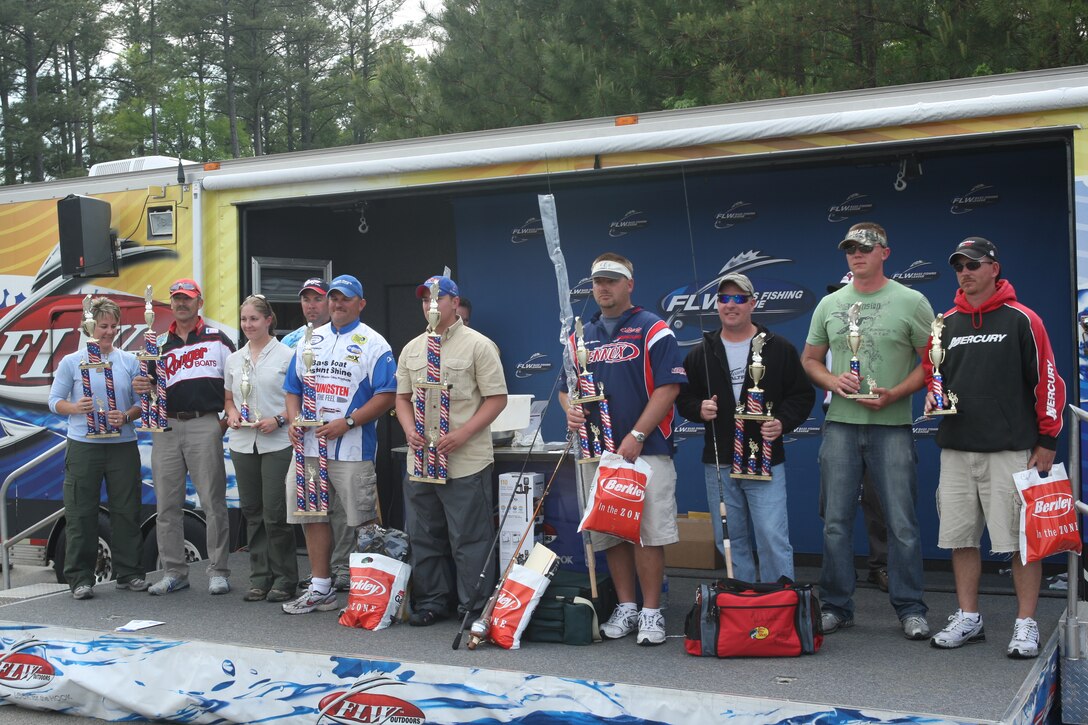 The first and fifth place winning teams stand with their trophies and equipment after the final bass weigh-in at Lake Jordan, April 23. Service members teamed up with civilian fishermen in a free, non-profit military appreciation event, making new friends, and for some, discovering a new-found love in fishing.