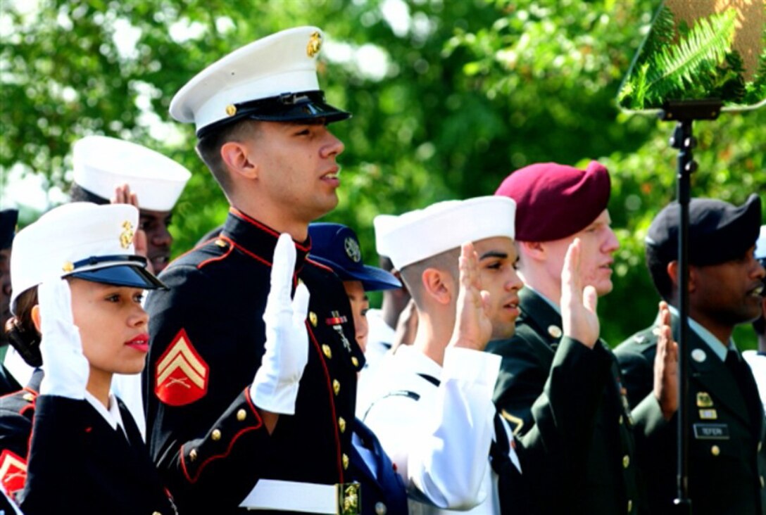 Cpl. Charlyston Schultz (second from left), a personnel clerk with the Installation Personnel Administration Center, Headquarters and Support Battalion, Marine Corps Base Camp Lejeune, takes the citizenship oath at a naturalization ceremony for U.S. service members at the White House, Washington D.C., recently.  Schultz, a native of Uberlandia, Brazil, met President Barack Obama just moments after becoming a U.S. citizen.