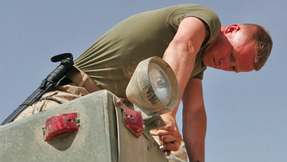 Motor Transport Marine working dilgently to repair equipment