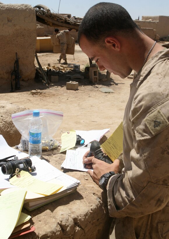 Corporal Jonathan Mezzancello, the 3rd Battalion, 6th Marine Regiment, optics technician, inventories night vision goggles and other serialized gear during the XO's Road Show in Marjah, Helmand province, Afghanistan, April 24, 2010. The XO's Road Show is a mobile exhibition which provides special services, assets and a resupply to each of the battalion's line companies. (USMC photo by Lance Cpl. Tommy Bellegarde)