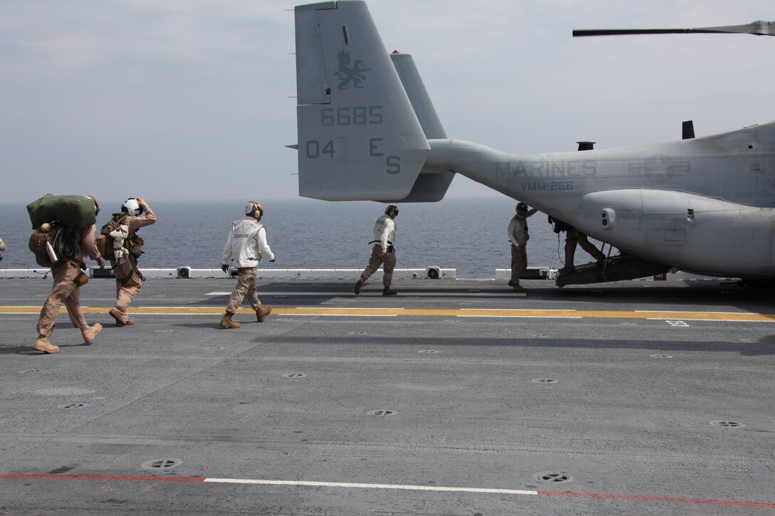 Marines with 26th Marine Expeditionary Unit board an MV-22 Osprey with Marine Medium Tiltrotor Squadron 266, 26th Marine Expeditionary Unit, during flight operations aboard USS Kearsarge, April 23, 2010. 26th MEU is embarked aboard USS Kearsarge, USS Carter Hall, and USS New York for Amphibious Squadron (PHIBRON)/ Marine Expeditionary Unit Integration (PMINT) training. PMINT integrates 26th MEU Marines with their Navy counterparts to train in planning and execution of missions they could conduct when they deploy together this fall.