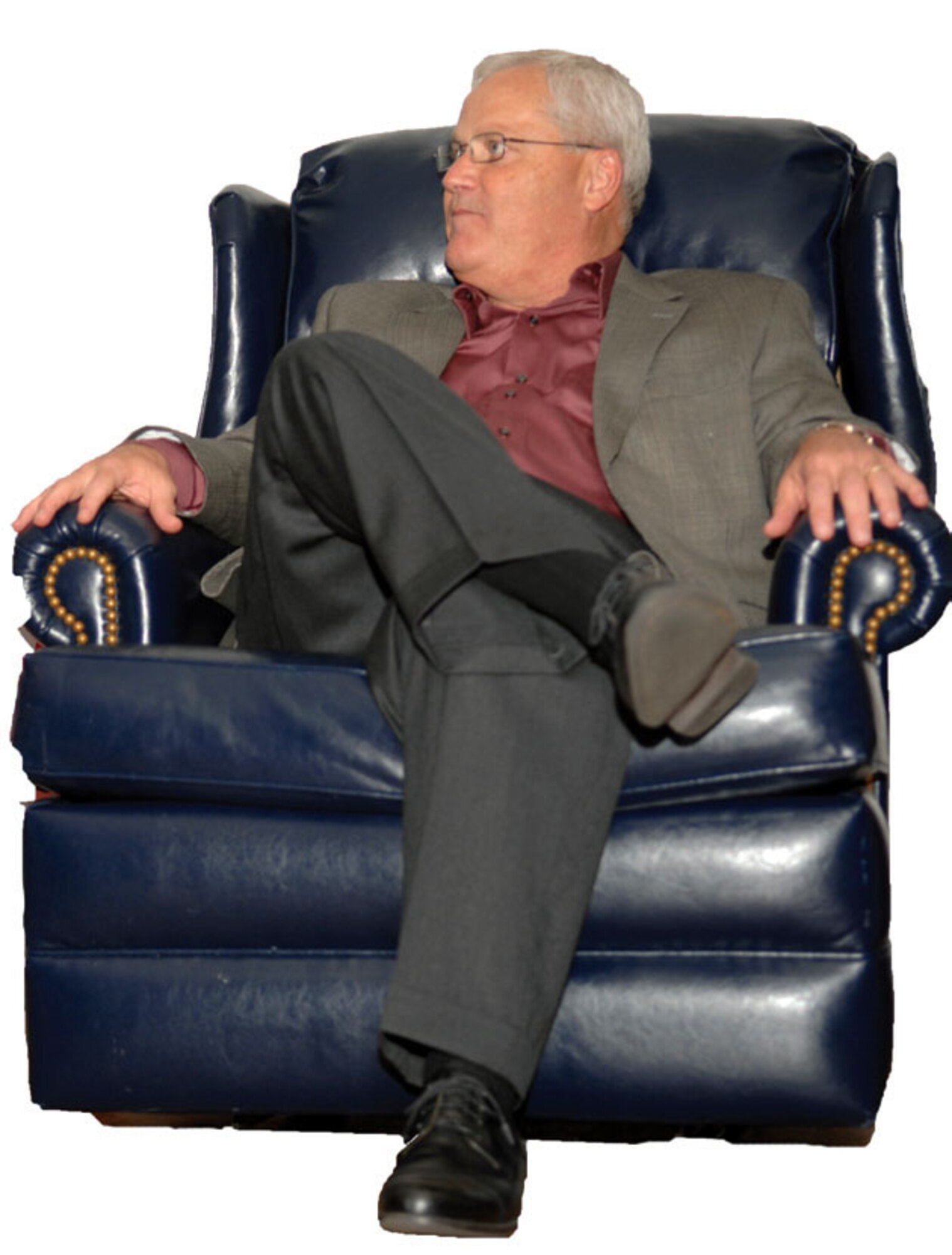 After changing into his new uniform (civilian clothes), retired Brig. Gen. James Melin relaxes in a recliner on stage. (U.S. Air Force photo)
